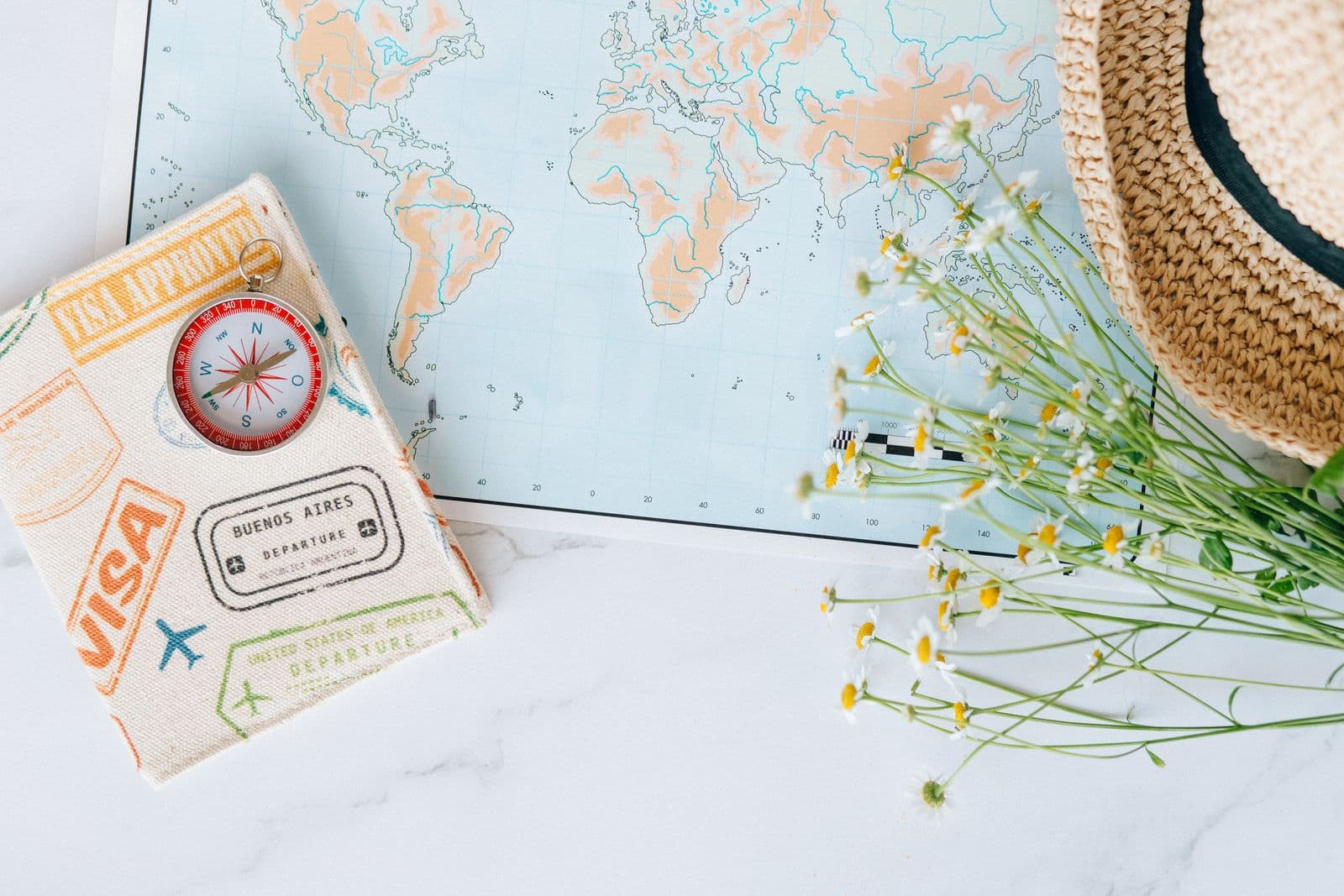 Trip-planning essentials — a world map, passport, and compass